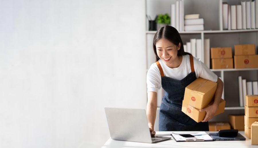 Businesswoman navigating QuickBooks Workforce on a laptop.