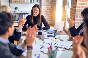 A group of people sitting around a table.