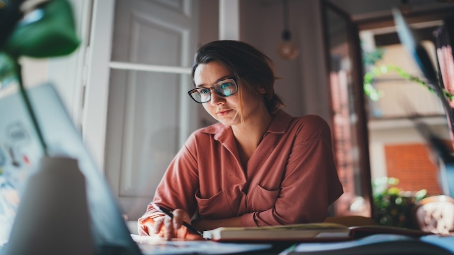 A person sitting at a desk with a laptop.