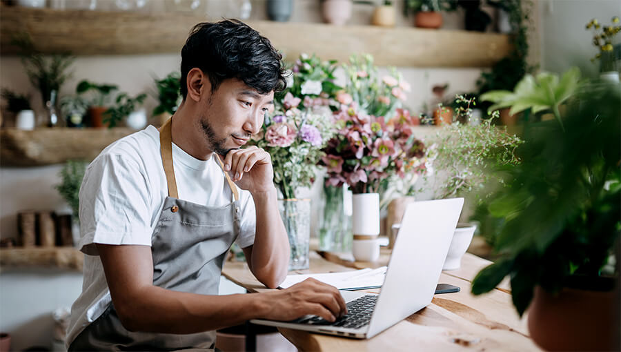 An image of a small business owner working on a laptop to update their new business website.