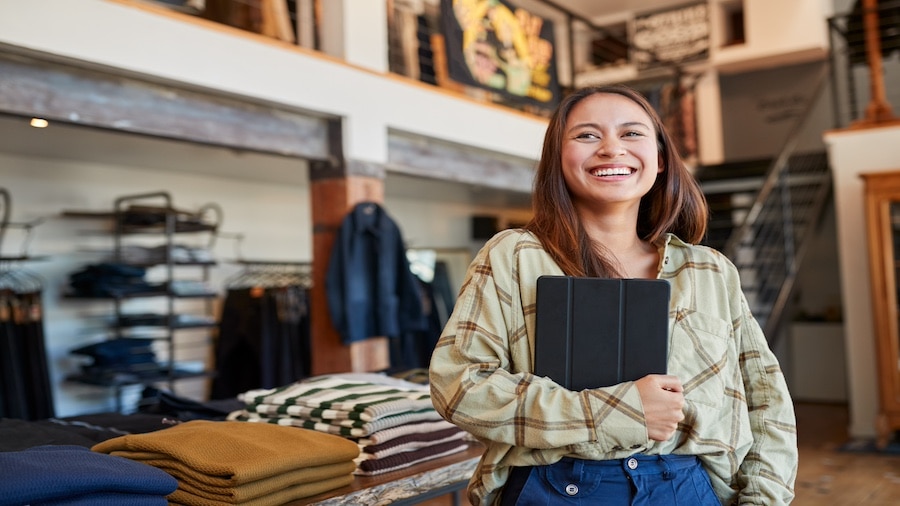 A person holding a laptop in her hands.