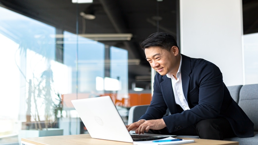 A person sitting at a desk with a laptop computer.