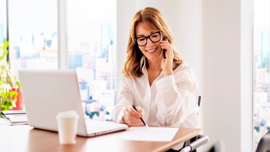 A person sitting at a desk with a laptop.