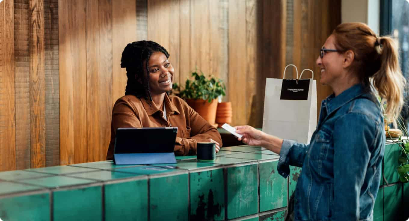 QuickBooks Online customer accepting a credit card payment from retail store customer