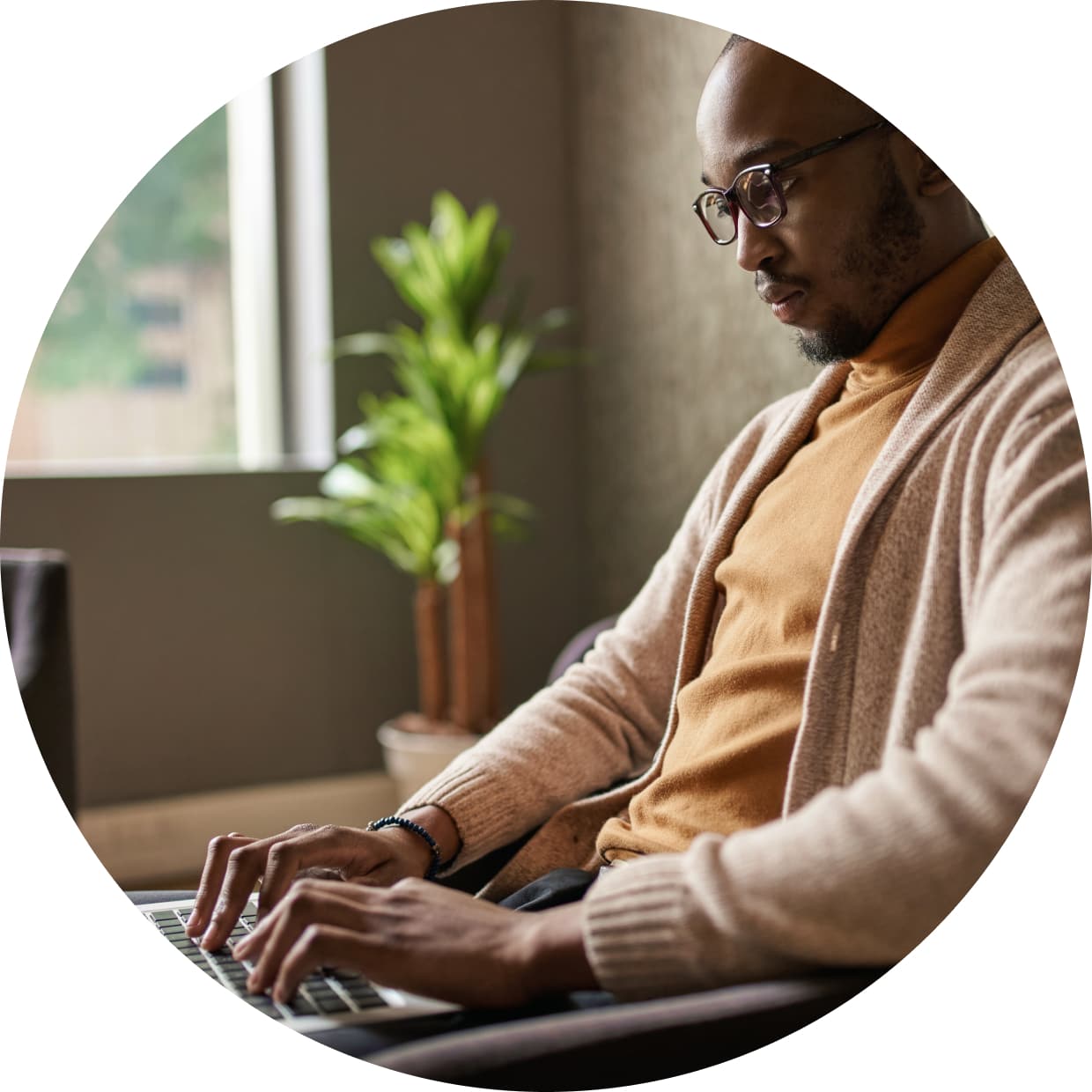 A person sitting at a desk with a laptop computer.