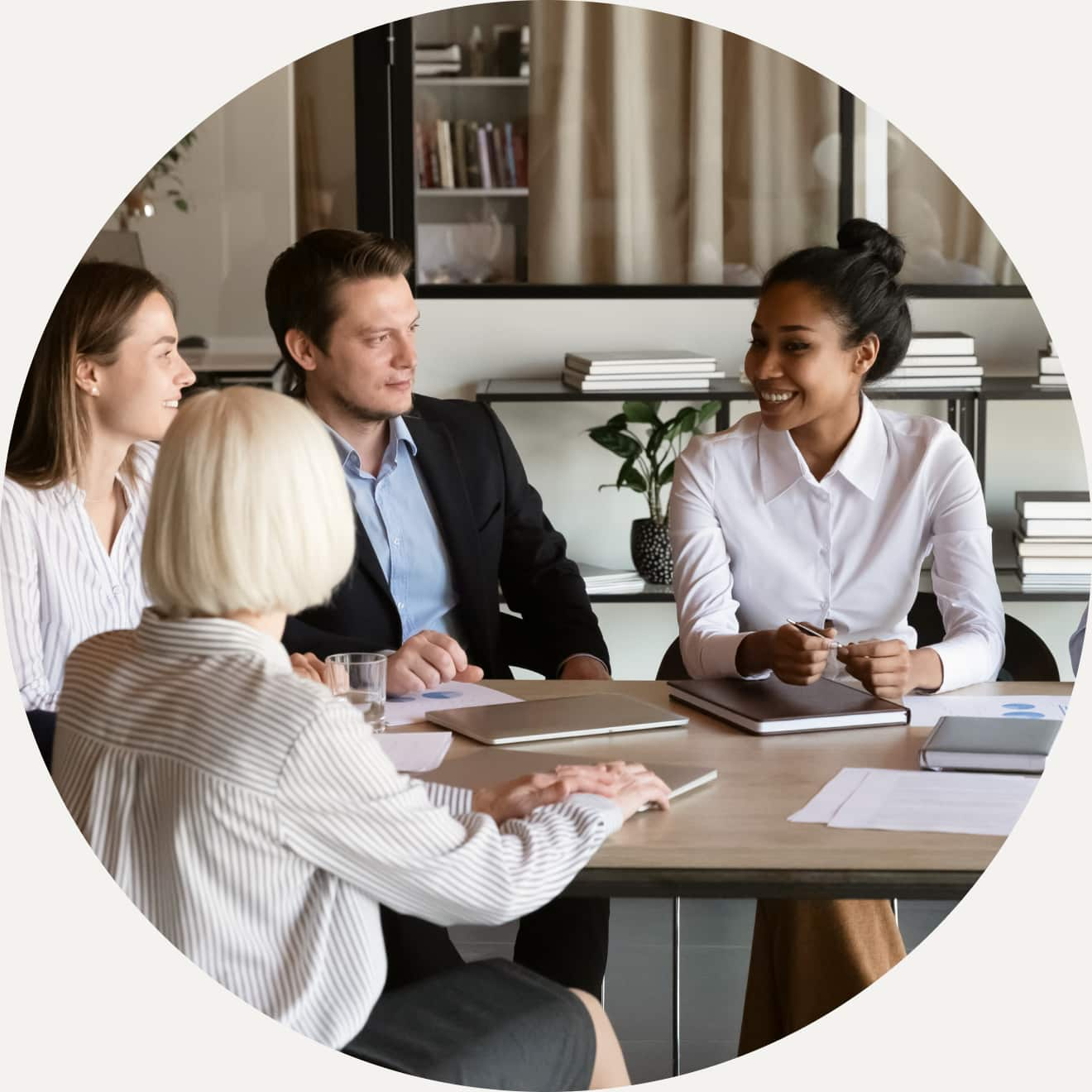 A group of people sitting around a table.