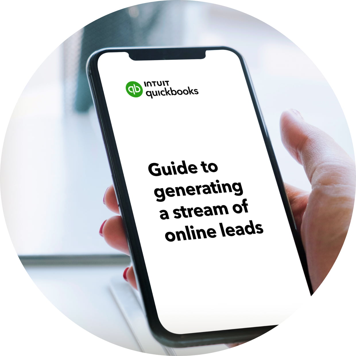 Woman holding a smart phone with the QuickBooks guide to generating a of online leads on screen