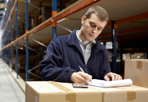 Man working on inventory in warehouse 