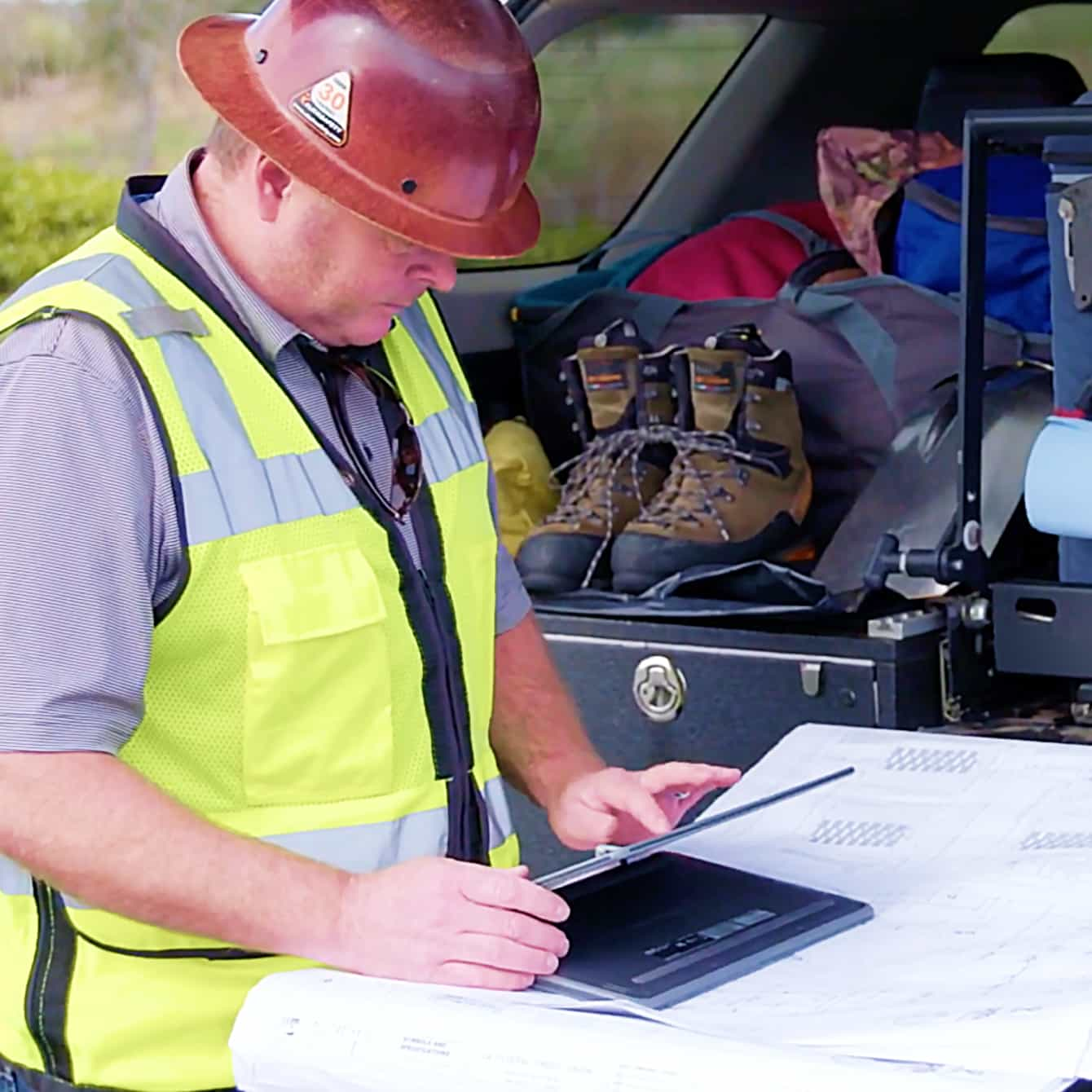 Male contractor working at job site on tablet