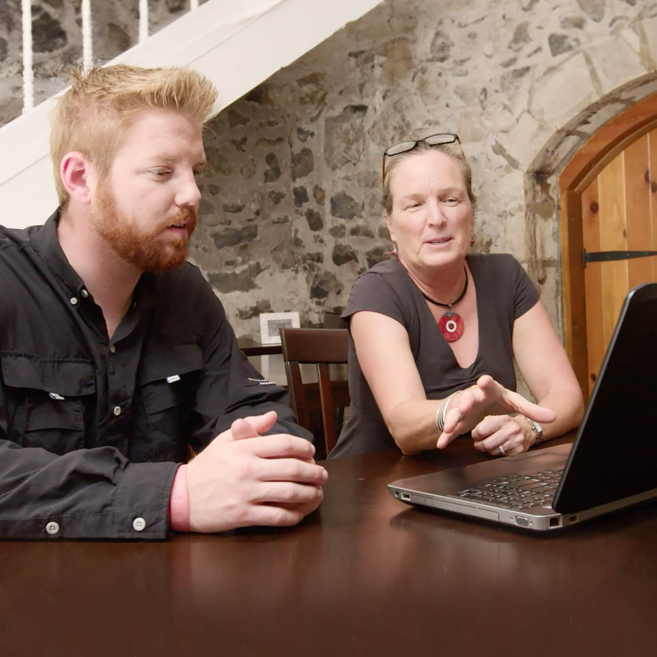 Man and woman working on a laptop together