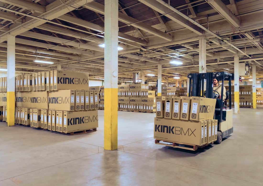 QuickBooks Enterprise customer KinkBMX warehouse man on forklift moving product boxes