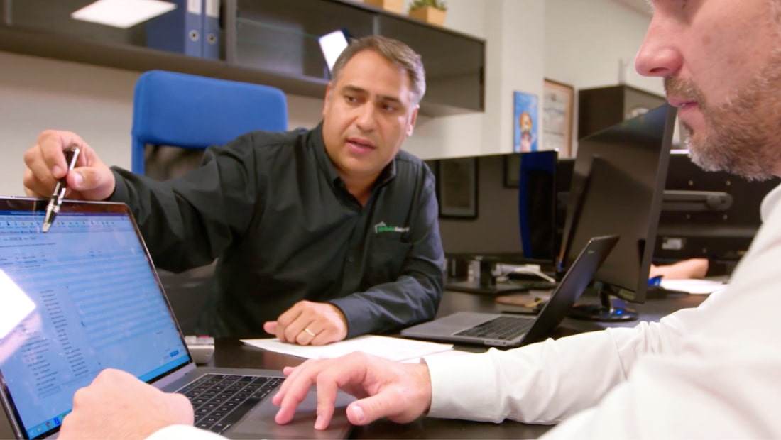 Male professionals collaborating on a laptop computer