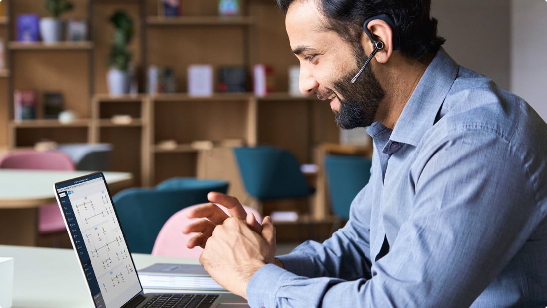 Male QuickBooks Priority Circle support agent on laptop computer talking with customer