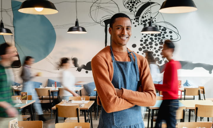 Male restauranteur in busy restaurant