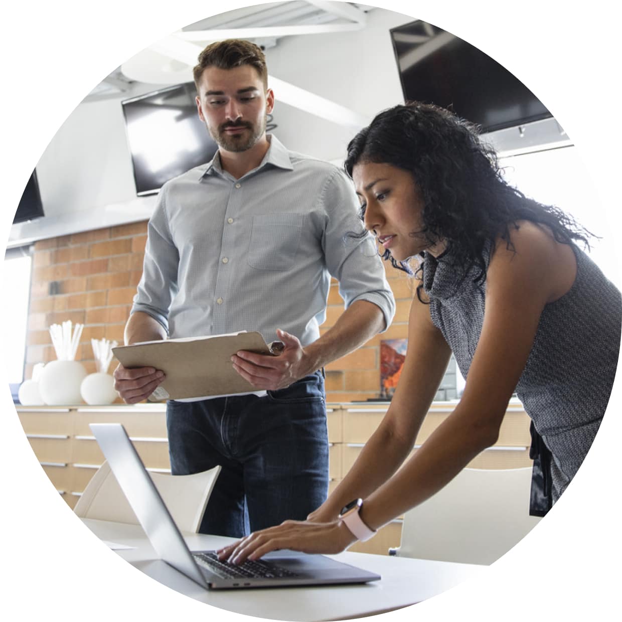 Man and woman working on laptop using QuickBooks Enterprise