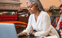 Woman on laptop watching QuickBooks Enterprise tutorial video