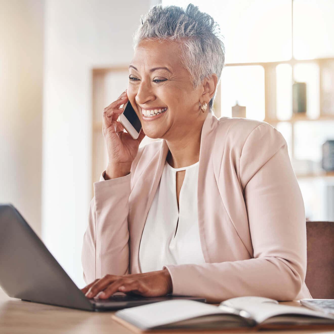 An accountant at her laptop smiling