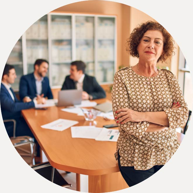 Professional woman standing at the end of a conference room table 