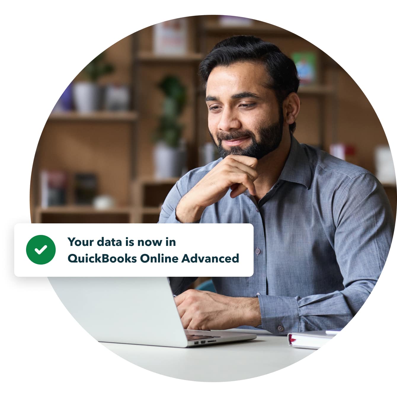 Satisfied male business owner successfully completes data transfer to QuickBooks Online Advanced