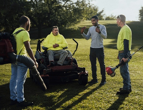 Landscaper directing the team while working on-site at a field.