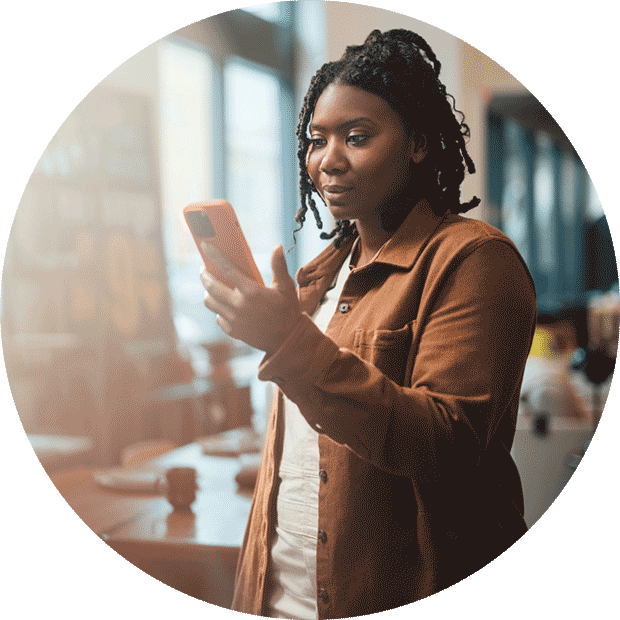 Business owner looking at a phone in a retail store.