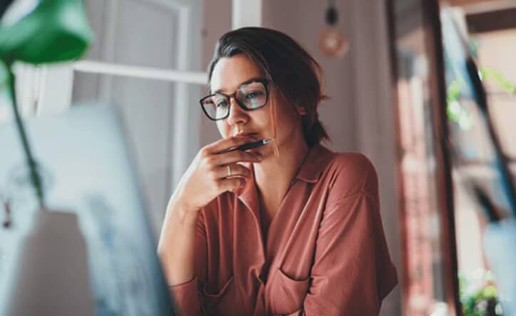 A person sitting at a table with a laptop.
