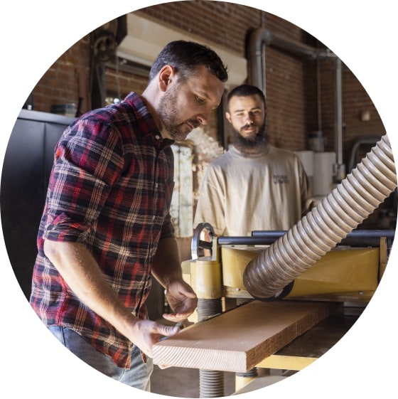 Men working in woodworking workshop.