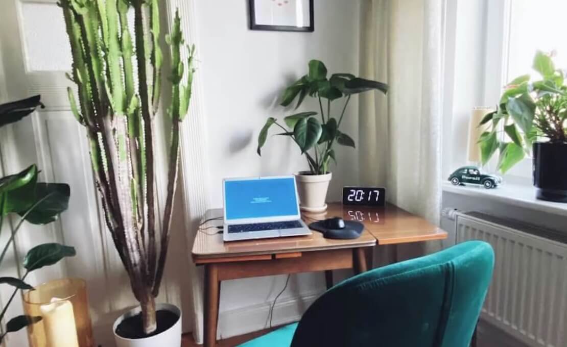 A photo of an open laptop on a desk in a home office.