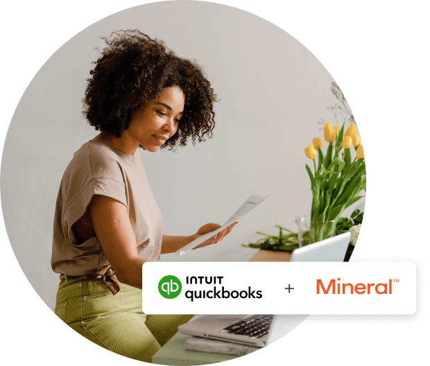 A person holding a laptop computer with mushrooms on it.