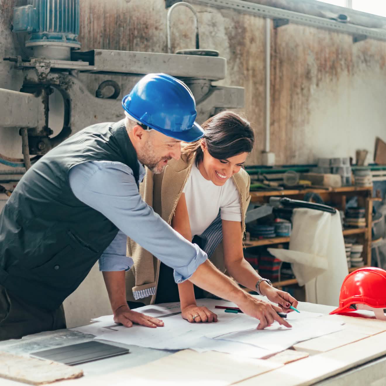 A couple of people standing in front of a table.