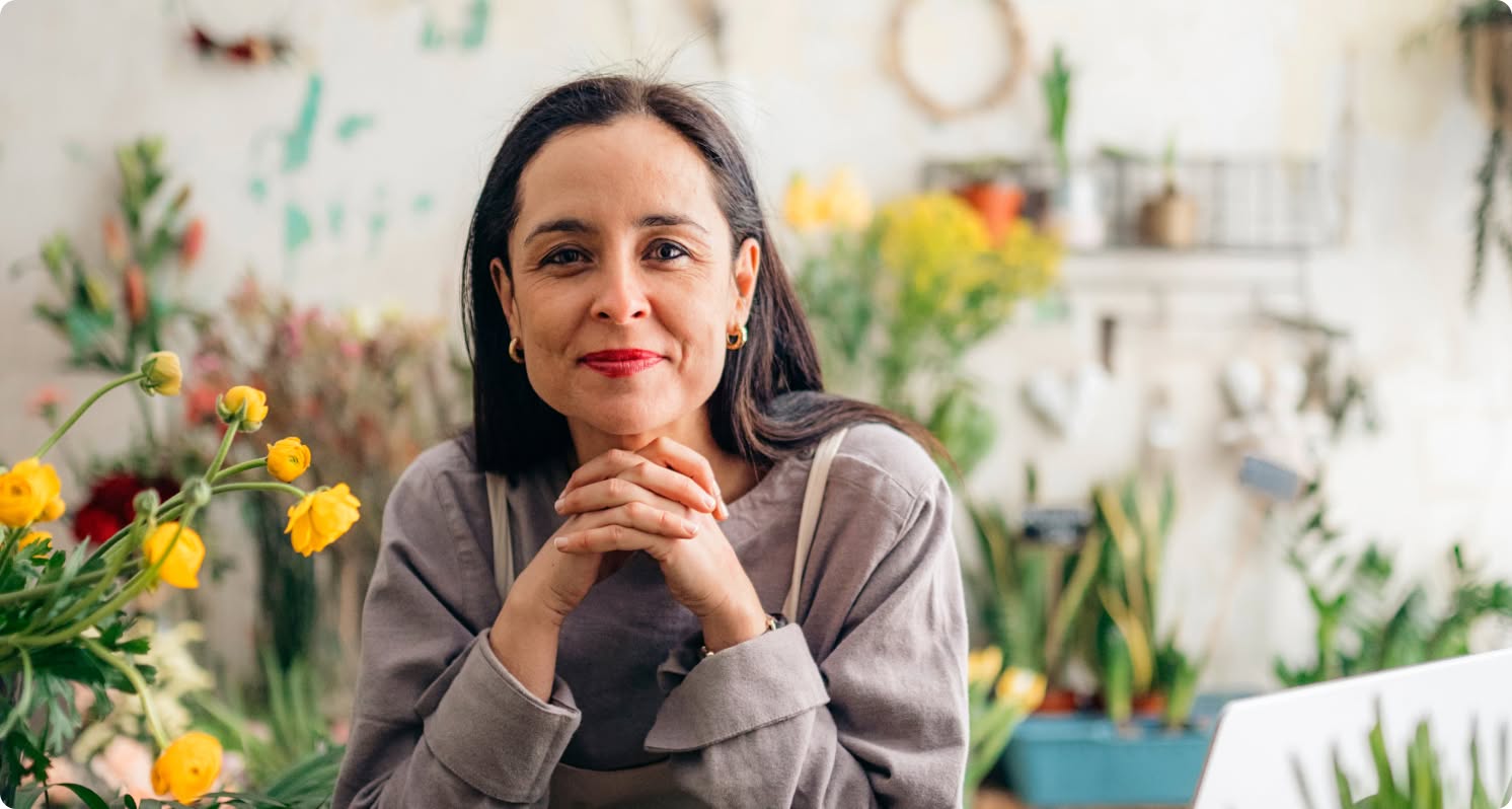A person sitting at a table with a glass of orange juice.