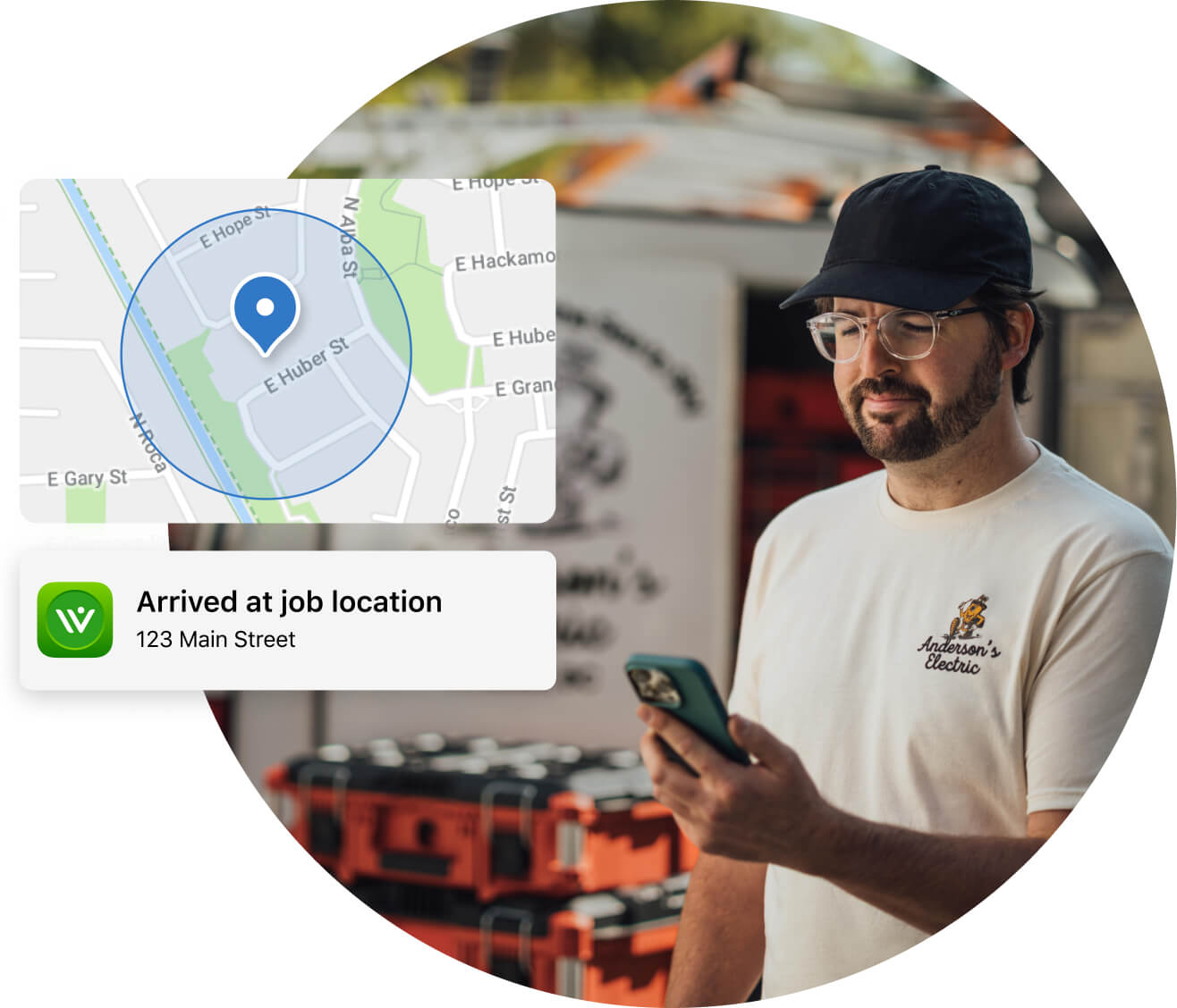 Person standing in front of the truck and the equipment in the background, holding a phone in his hand and a snapshot showing the job location.