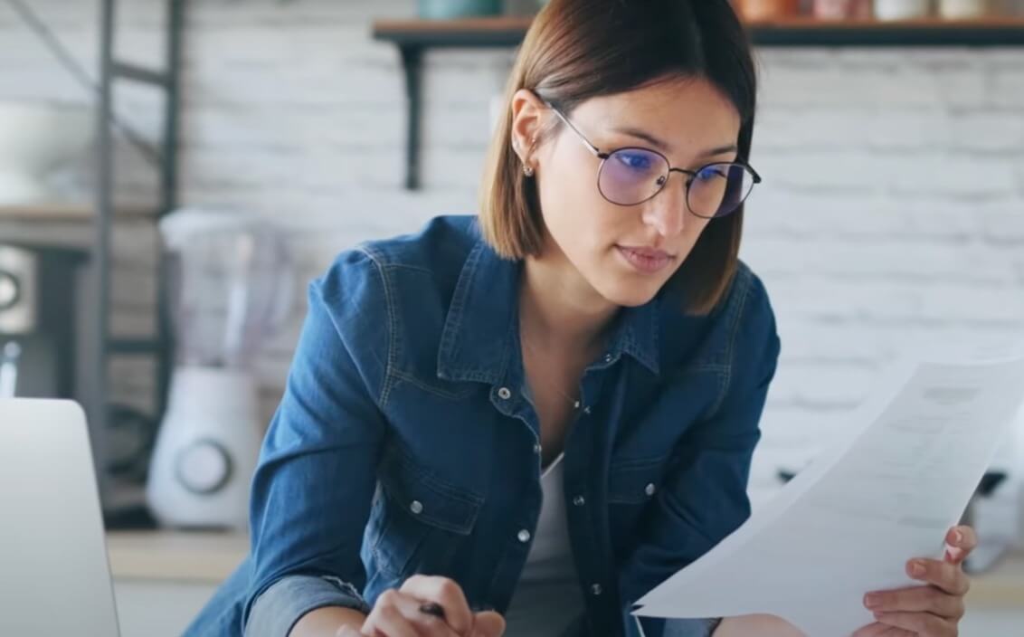 woman with eyeglasses reading document