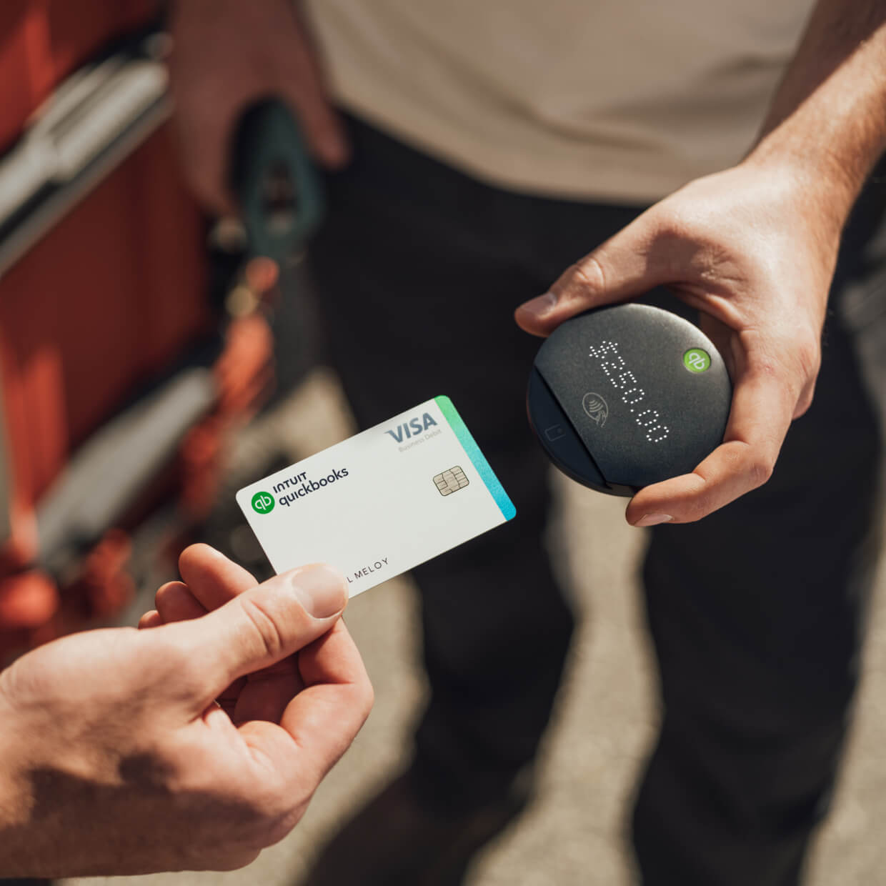 Electrician taking payment from a customer with a portable point of sale device.