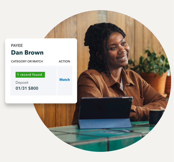 A small business owner smiling at a customer with a snapshot of QuickBooks matching a transaction