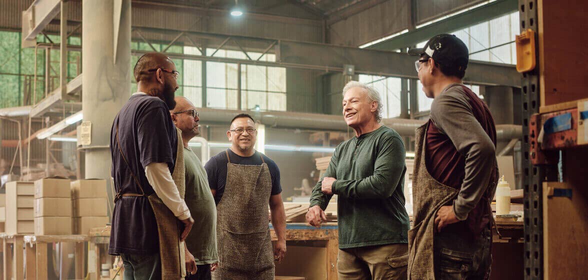 People talking in a group in a manufacturing facility