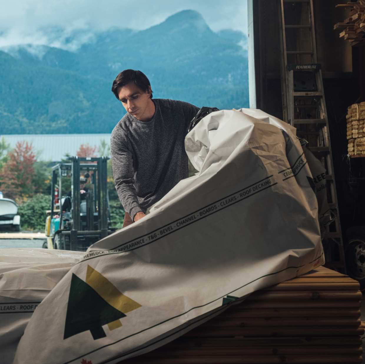 Business owner uncovering production materials in a manufacturing warehouse.