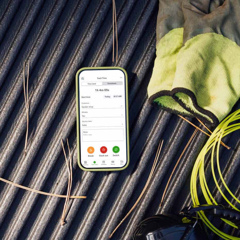 Device on a flat surface surrounded by protective gear and time tracker on screen. 