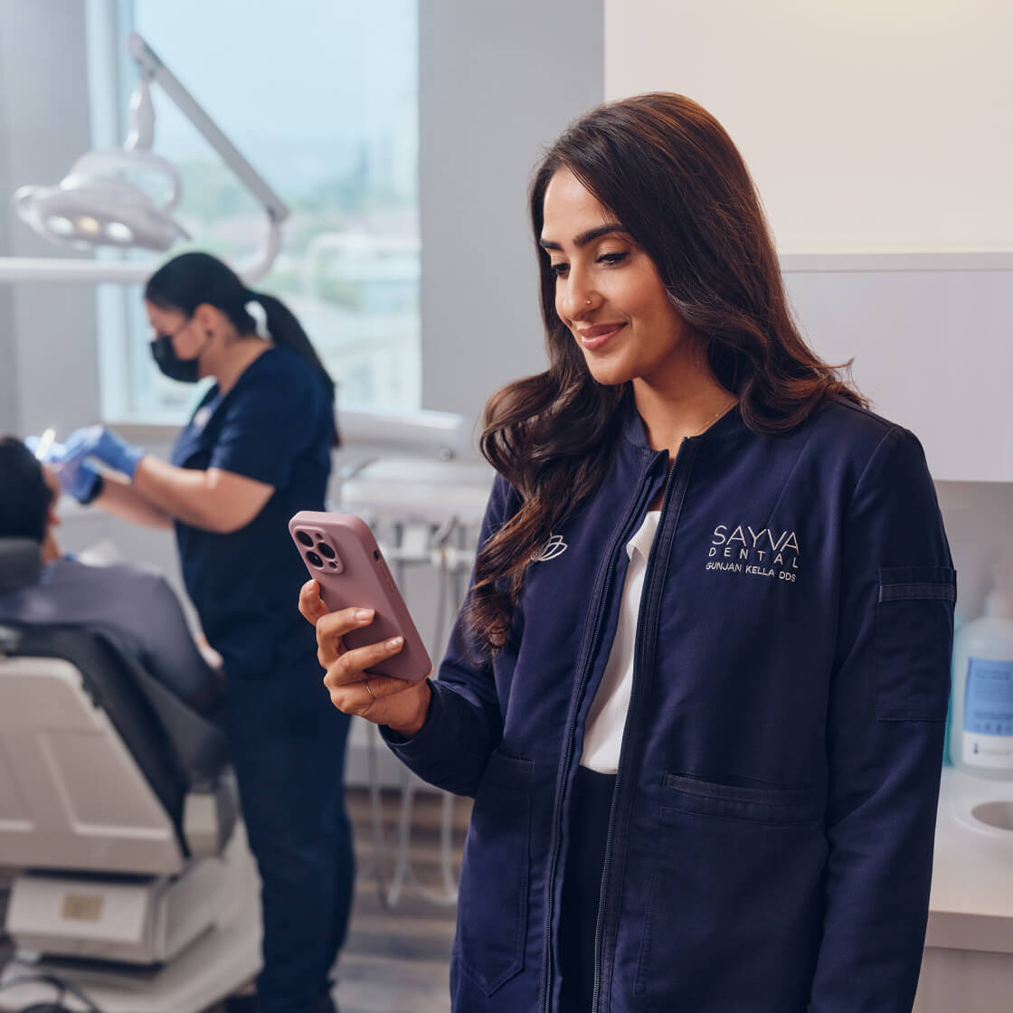 Person looking at a phone in a dental office