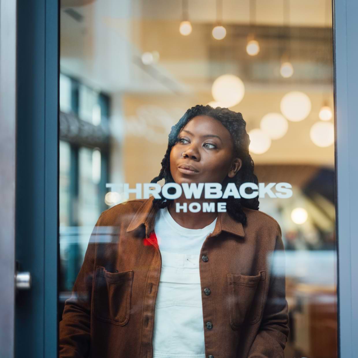 Person looking outside through a glass door