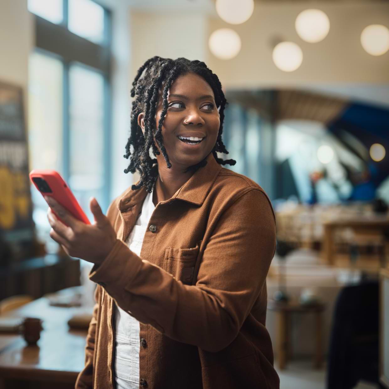 Person working on a phone and smiling