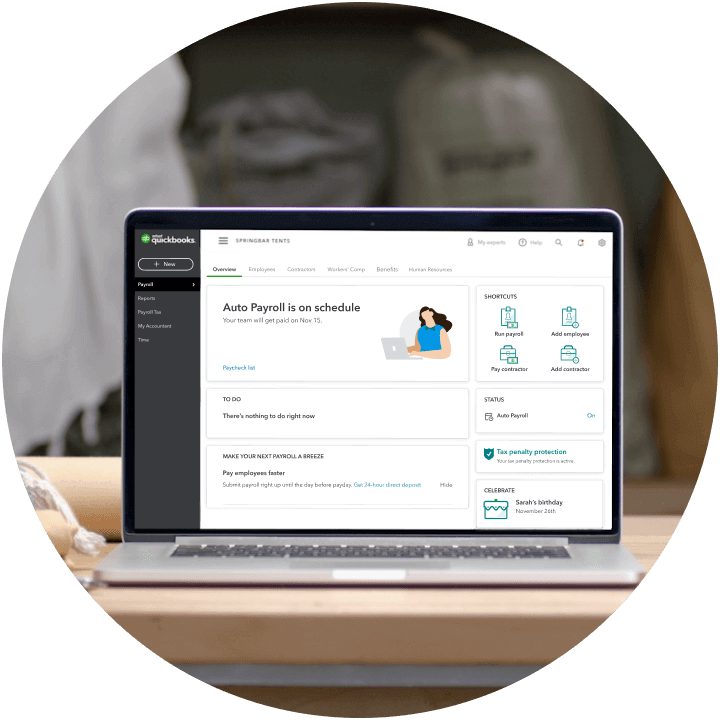 Open laptop in a work space with QuickBooks Payroll displayed on screen. 